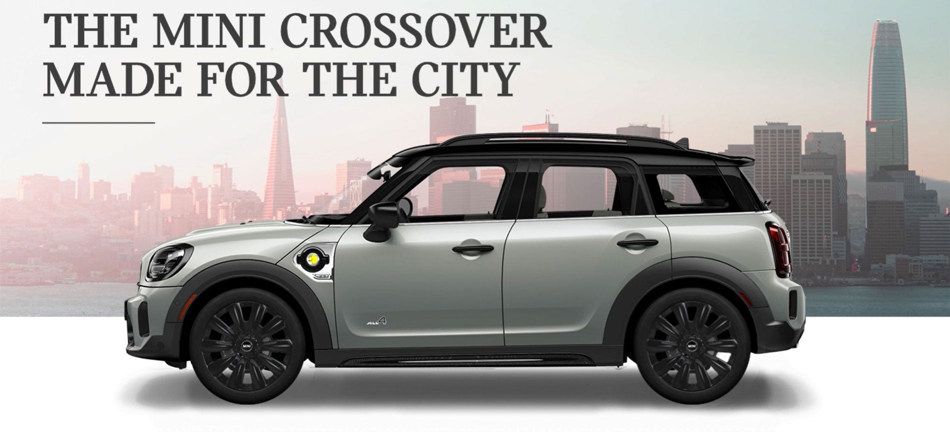 The MINI Cooper SE Countryman PHEV parked in front of a city scape. MINIDemo1 in Derwood MD