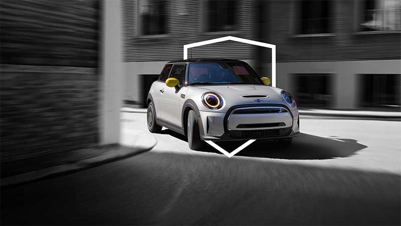A MINI Electric Hardtop S 2 Door rounds a corner.