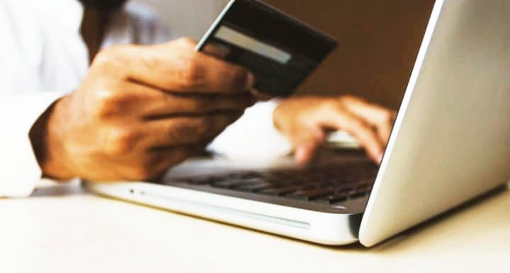 Hand holding credit card in front of open compute | MINIDemo1 in Derwood MD