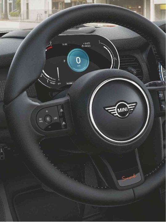 Closeup view of the heated multi-function steering wheel in a MINI Cooper S Convertible Seaside Edition.